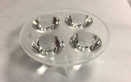 En plastbas med fyra klart 3D-linser på en vit bakgrund.