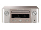 Marantz MCR-612 nätverksreceiver med CD & radio, silver/guld En silver/guld nätverksreceiver med CD-spelare och radion, visande låtinfo.