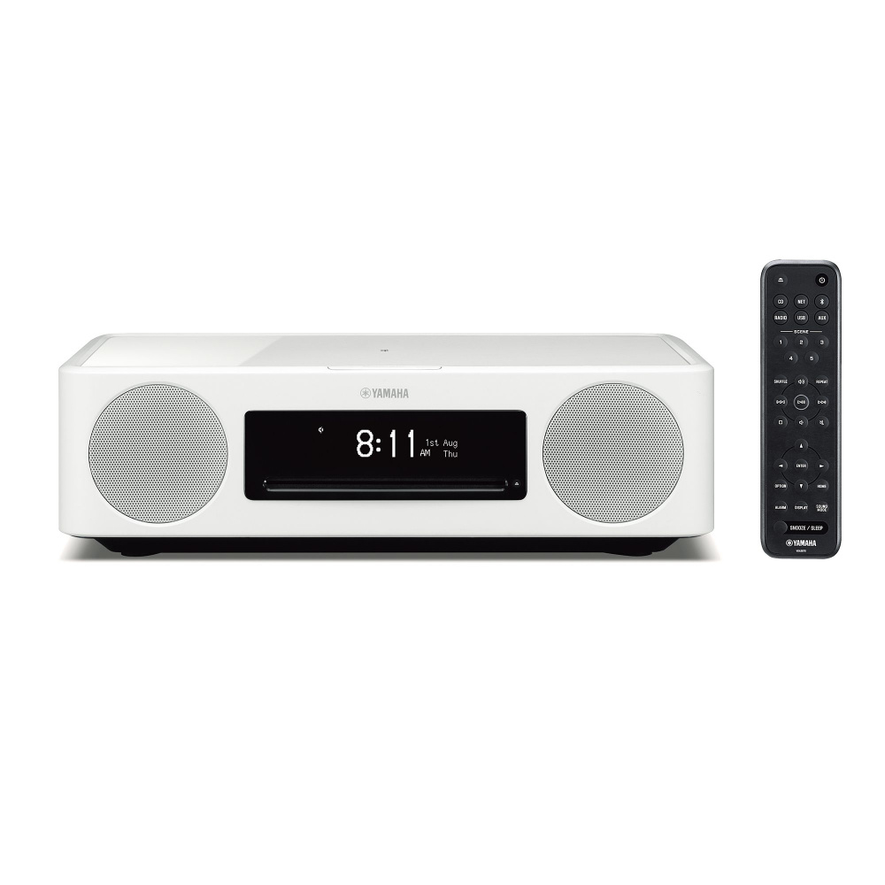 Vitt ljudsystem med klockdisplay och fjärrkontroll.