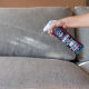 Chemical Guys Hydrothread Ceramic Fabric skyddar tygklädsel, 473 ml En hand sprayar en flaska Hydrothread på en tygsoffa.
