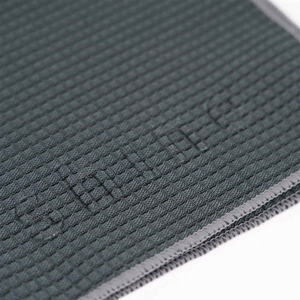 En mörk grå mikrofiberduk med struktur och sydda kanter.