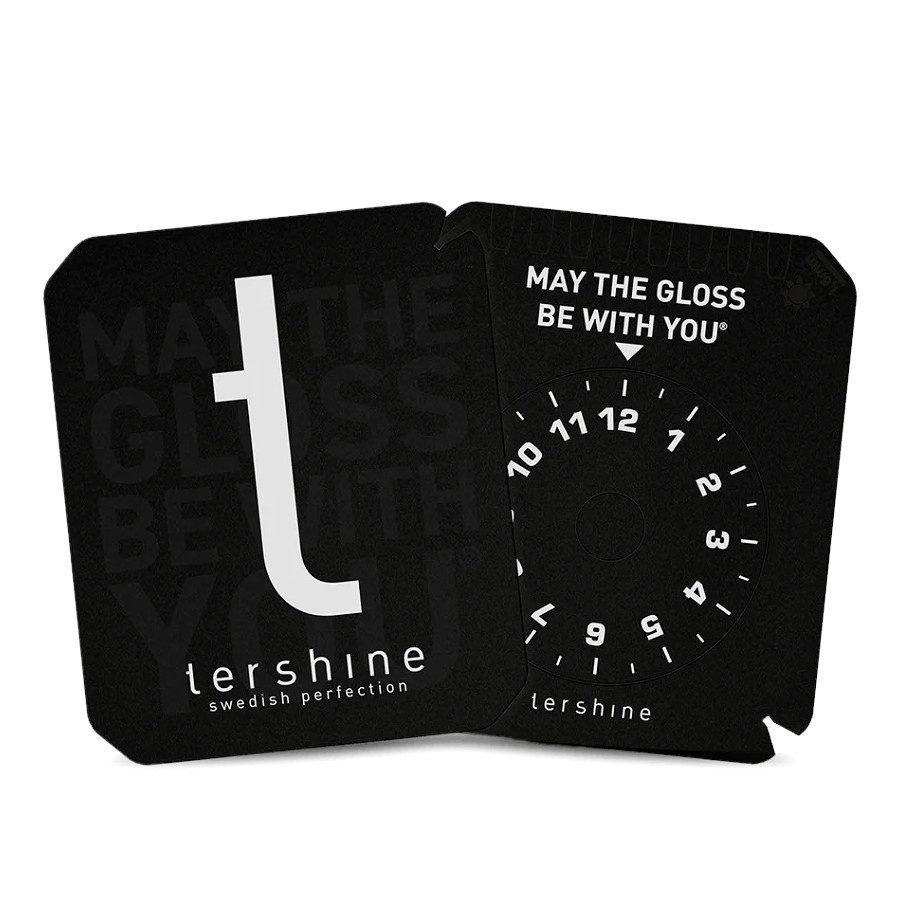 Isskrapa med svart design och text, inklusive en cirkel för mätning.