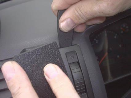 En hand justerar eller tar bort en del av bilens inredning.