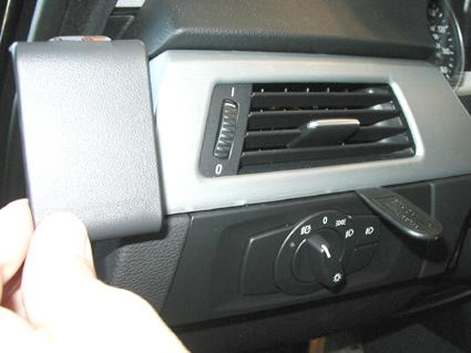 En del av bilinteriör, troligen kontrollpanel med luftventil och knappar.