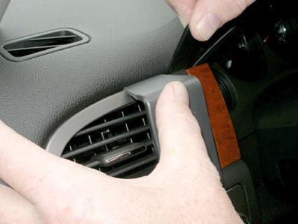 Hand som justerar eller tar bort en del av interiören i en Chevrolet Avalanche.