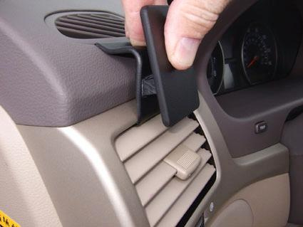 En hand som justerar luftutsläpp i en bilpanel.