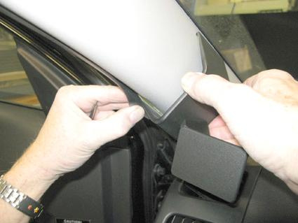 En person installerar en del av inredningen i en bil.