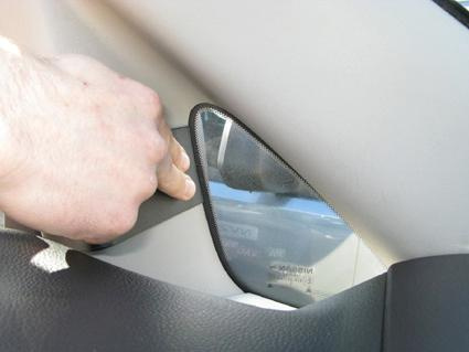 En hand justerar en del av inredningen i en Nissan NV200.