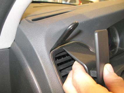 En hand justerar luftutloppet i en Volvo S60 11-15.