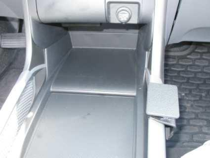 En konsol i en Honda Pilot 03-08, med plats för förvaring.