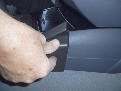 En hand håller i en del av en BMW-konsol.