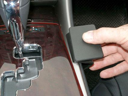 En hand håller i en konsol för automatväxling i en Lexus IS.