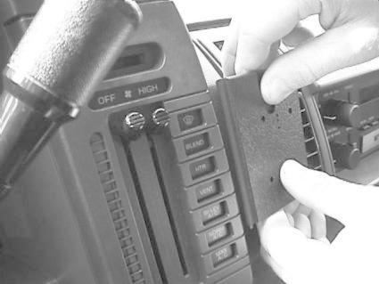 En hand monterar en bygel på instrumentpanelen i en Chevrolet Astro.