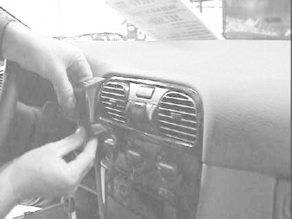 Montering av en anordning på instrumentbrädan i en Volvo S40.