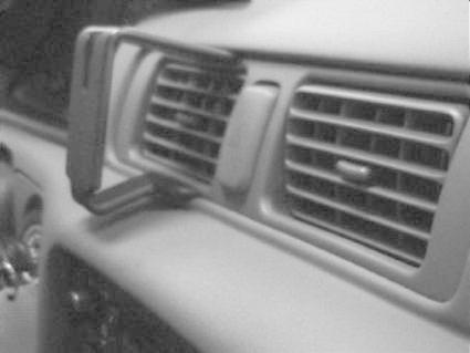 En mobilhållare fäst vid luftventilen i en bil.