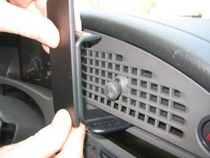 En person monterar en träpanel i en Saab 9-5 instrumentbräda.