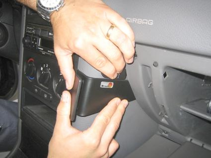 Händer monterar en del av instrumentpanelen i en Opel Astra 98-03.