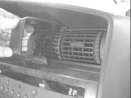 En hand justerar luftventilen i centrum av Opel Omega 00-05.