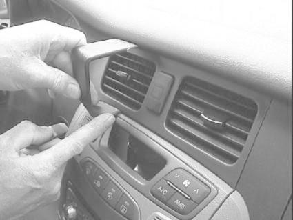 En hand justerar luftutloppet i en bilinteriör.