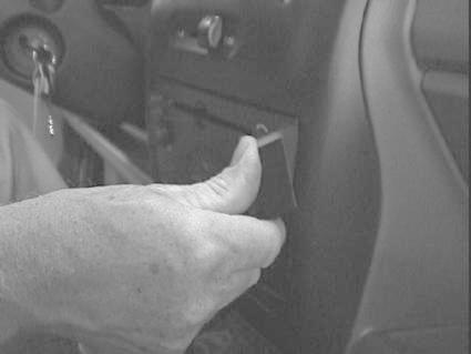 En hand installerar en monteringsbygel i en Opel Agila.