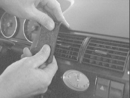 En person håller i ett föremål mot en bils instrumentpanel.