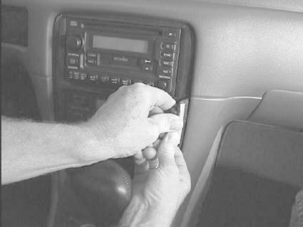 En person installerar en stereo i en Toyota Camry 97-01.