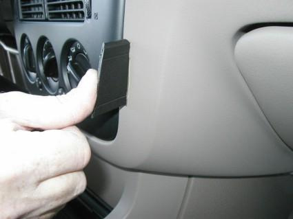 En hand trycker på en knapp inuti Ford Explorer från 02-05.