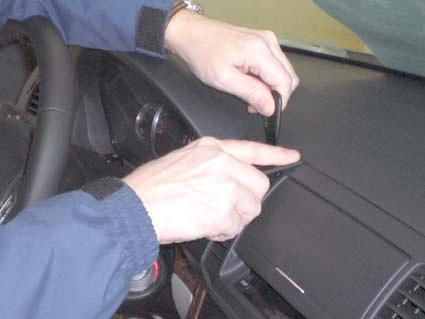 En person använder ett verktyg på instrumentbrädan i en Subaru Outback/Legacy.