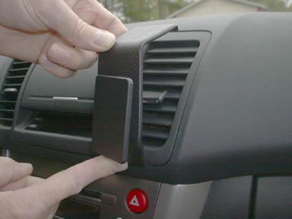 En hand som fäster en del på en bils inredning.