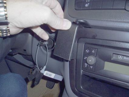 En hand håller i en del av instrumentpanelen i en Mercedes Benz Vito.