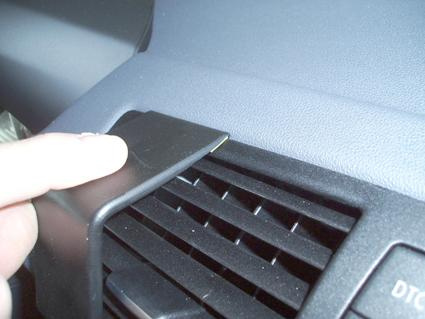 Del av inredning med luftutlopp och hand som justerar komponent.