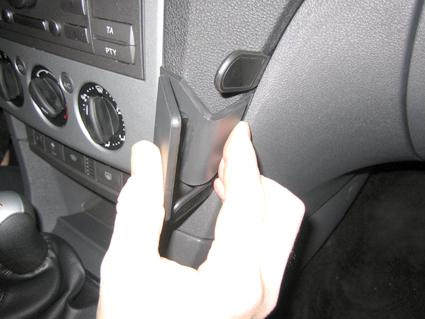 En hand justerar en del av interiören i en Ford Focus 05-10.