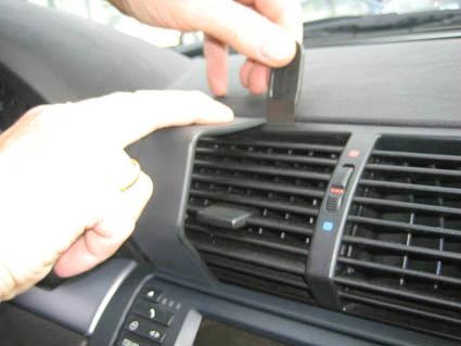 Man handskas med luftventil och navigationssystem i en BMW X5.