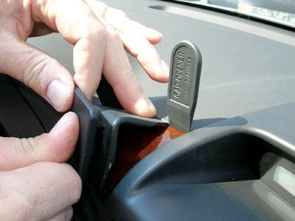 Verktyg används för att avlägsna en del av instrumentpanelen i en Kia Carnival.