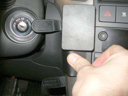 Bild visar en hand som trycker på en knappsats vid bilens instrumentbräda.