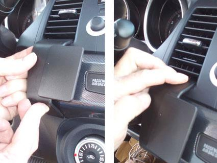 Del av instrumentbrädan i en Mitsubishi Lancer, hand som justerar en komponent.