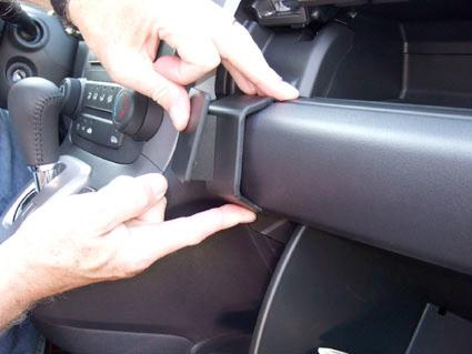 En person installerar eller justerar en vinklad del i en Honda CR-V 08-11.