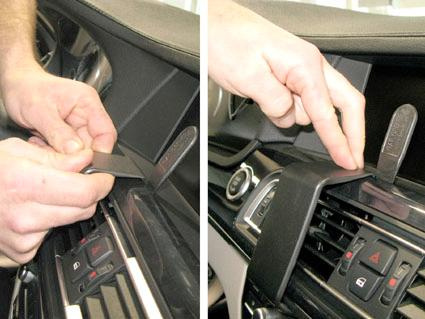 Två händer som justerar paneler i en BMW 730-750 F01, F02.