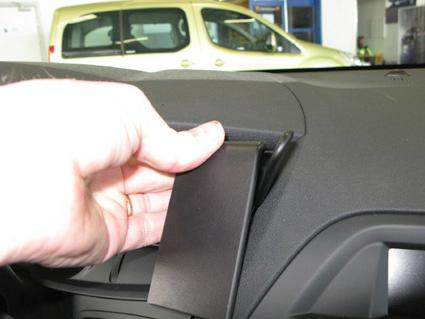 En hand flyttar en del på instrumentbrädan i en Citroën C5 III.