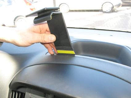 En hand håller upp ett fäste för Hyundai H1 inuti bilens instrumentpanel.