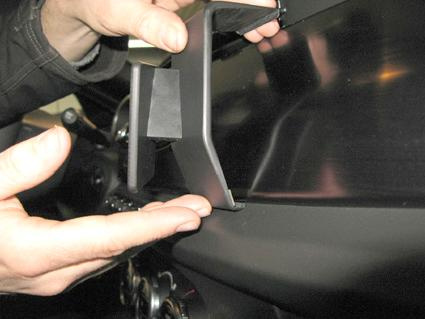 En hand installerar en komponent i Alfa Romeo Giulietta dashboard.