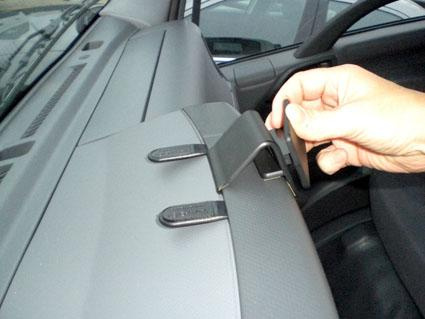 En hand justerar en produkt på instrumentbrädan i en Chevrolet.