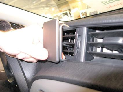 En hand justerar luftutloppet i en Toyota Yaris.