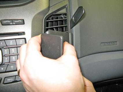 En hand fäster en del vid luftutloppet i en Ford Ranger.