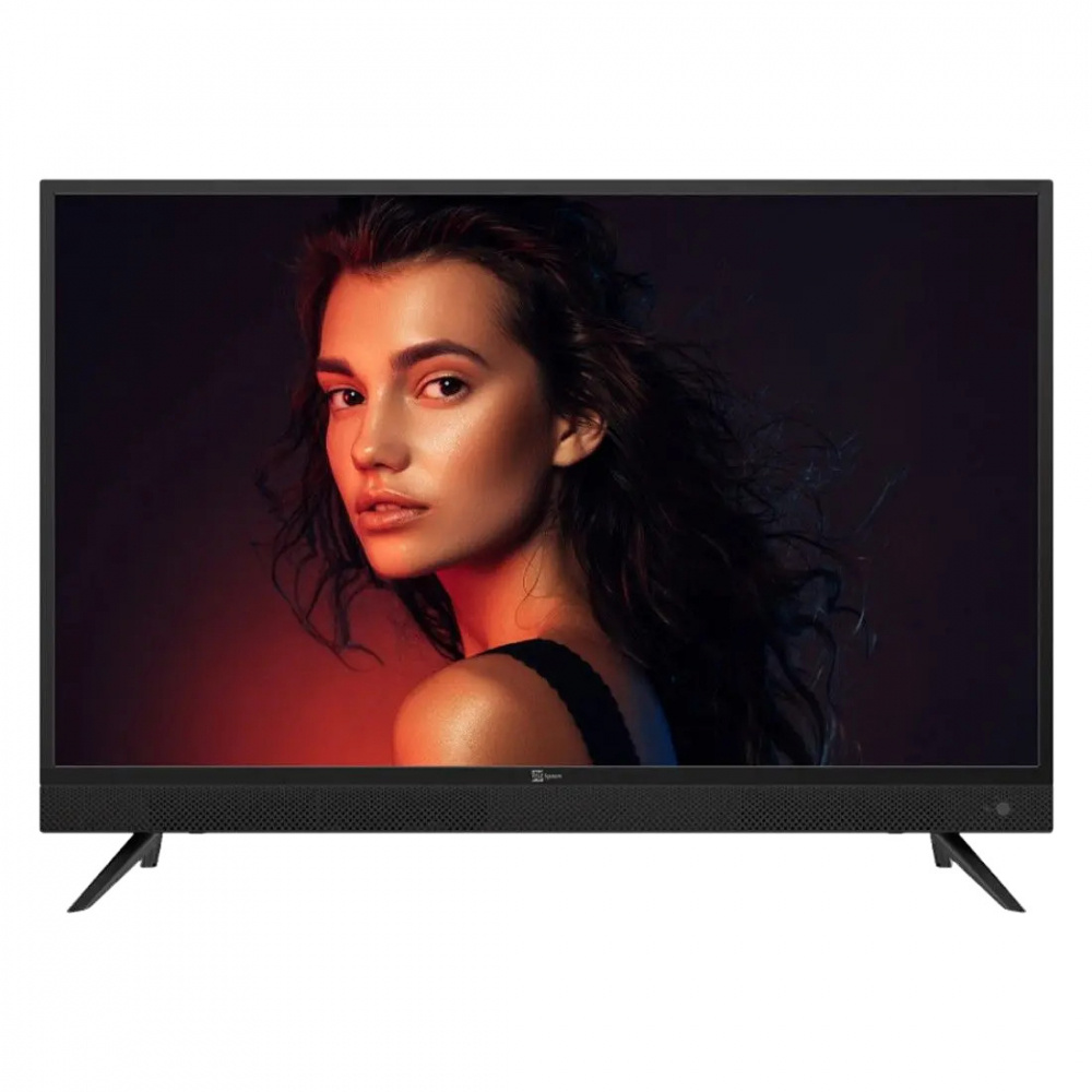 En TV med integrerad soundbar och en kvinna på skärmen i dämpad belysning.