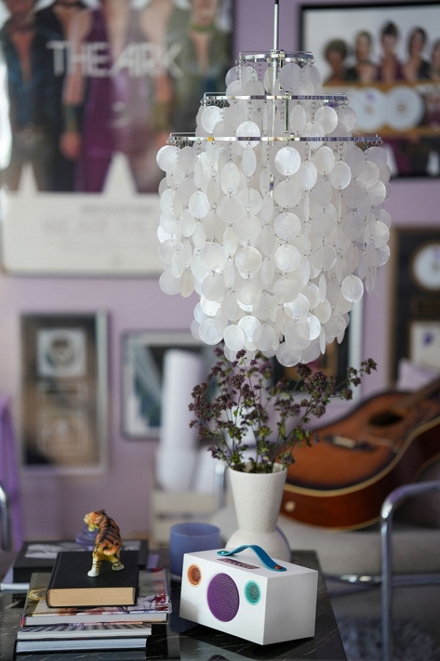 En modern högtalare i vitt och blått med dekorativ inredning och musikrelaterade föremål.