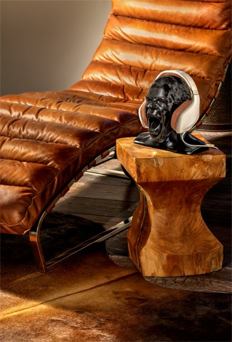 Ett hörlursställ i form av en skulptur, placerat bredvid en läderstol.