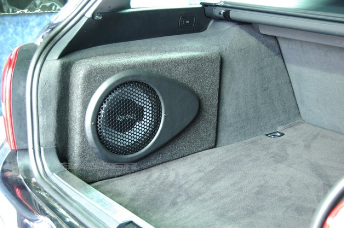 En baslåda installerad i bagageutrymmet på en Audi A4 Avant.