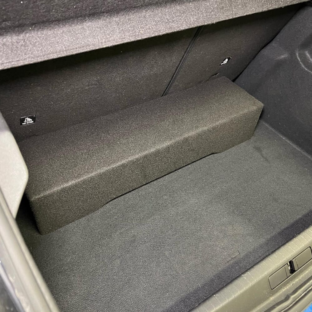 Tom baslåda i ett utrymme, sydd i svart material.