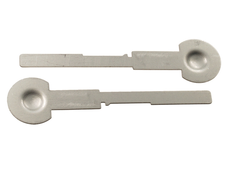 Två metallverktyg med rundade och platta ändar.